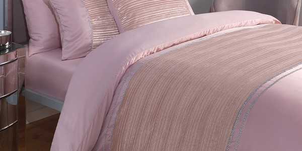 Pink bedding on bed.